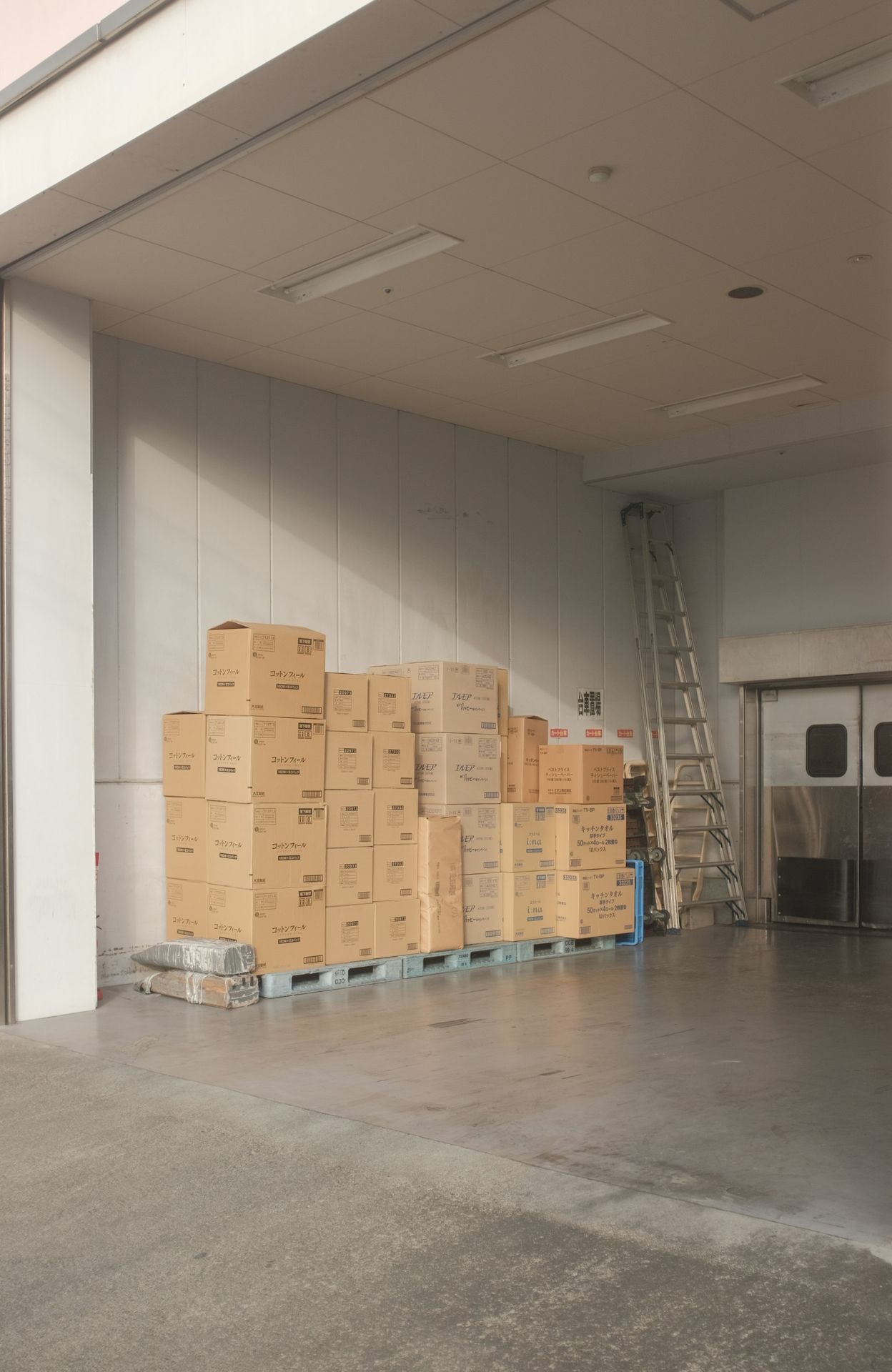 brown cardboard boxes on white floor tiles